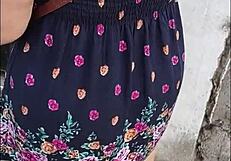 curvy mature woman walks street in skirt