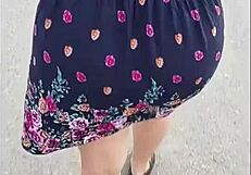 curvy mature woman walks street in skirt