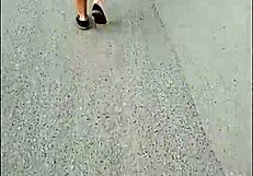 curvy mature woman walks street in skirt