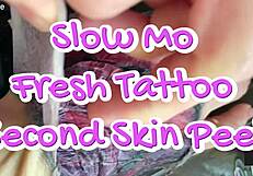 I observe slow motion of fresh tattoo skin peel.