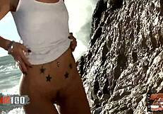 Nice blonde Nicky Wayne removes clothes by the sea