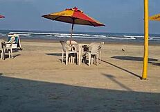 On the beach, she fingers her wet pussy under the sun.