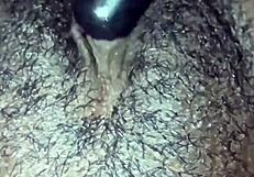 This ebony girl is playing with her hairy pussy