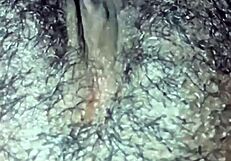 This ebony girl is playing with her hairy pussy