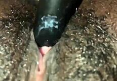 This ebony girl is playing with her hairy pussy