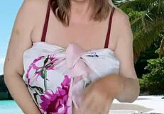 Hot granny showing off huge tits in tiny bikini