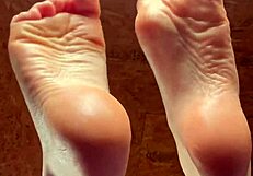 Girl Applies Lotion To Her Feet In A Relaxing Session