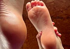 Girl Applies Lotion To Her Feet In A Relaxing Session