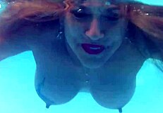 Melissa the mermaid swims in pool with tattoos
