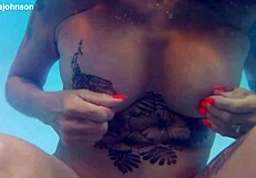 Melissa the mermaid swims in pool with tattoos
