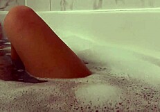 Petite brunette moans during orgasm in shower