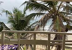 Hey, that ebony wife is flashing her pussy right at the beach house, feeling so bold outdoors