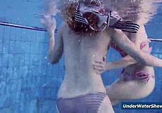 Horny girls strip each other in the pool, ripping clothes