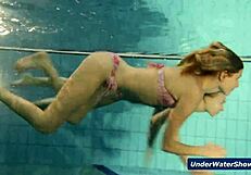 Horny girls strip each other in the pool, ripping clothes