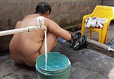 Bhabhi bathing outdoors naked.