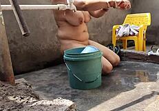 Bhabhi bathing outdoors naked.