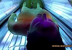 Beautiful woman masturbates on solarium cam
