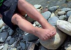 goddess teases with tan nylon soles and toes by the riverside, close-up fetish delight
