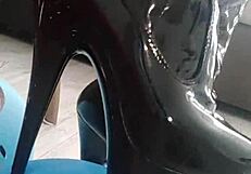 Veve performs balloon popping in latex stockings with a sharp