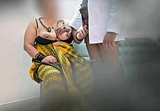 Doctor examines patient thoroughly in clinic setting