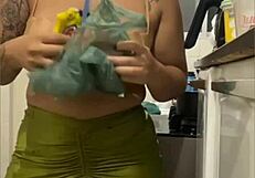 Young woman does live in kitchen, showing swollen pussy