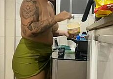 Young woman does live in kitchen, showing swollen pussy