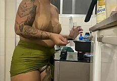 Young woman does live in kitchen, showing swollen pussy