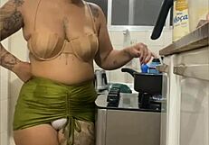 Young woman does live in kitchen, showing swollen pussy