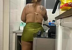 Young woman does live in kitchen, showing swollen pussy