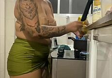 Young woman does live in kitchen, showing swollen pussy