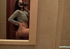 busty babe explores her hairy bush in the bathroom, fingering herself solo until climax