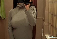 busty babe explores her hairy bush in the bathroom, fingering herself solo until climax