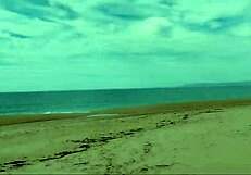 Guy on nude beach spills a lot of milk