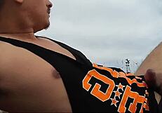 Guy on nude beach spills a lot of milk