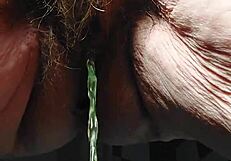 Oma plays and uses cucumber in hairy pussy