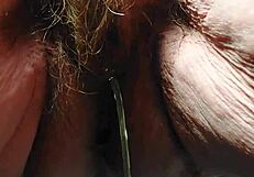 Oma plays and uses cucumber in hairy pussy