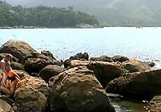 Mature Man Fucks Exotic Babe in Cap and Sunglasses on Seaside Stones.