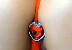 brunette engaging in extreme teasing with tits and butt plug