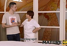 mature masseuse teases client by flashing charms and handing them over