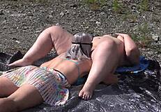 A lesbian washes her friend's pussy outdoors then licks to orgasm