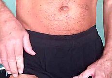 MUSCULAR PAPIFACHERO GRIPS HIS BULGE IN SOFT COTTON SHORTS, FEELING THE GREAT TEXTURE AGAINST HIS SKIN