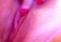 feeling the wetness of her pink pussy while masturbating