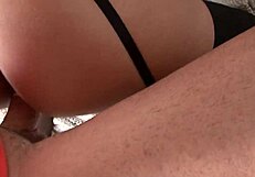 Mature woman in black lingerie shares an intimate moment