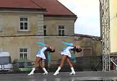 two nice majorettes perform cheerleading routines