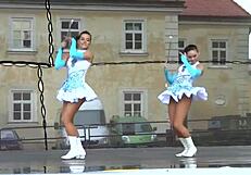 two nice majorettes perform cheerleading routines