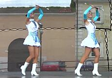 two nice majorettes perform cheerleading routines