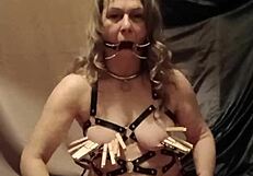 Slave in leather harness spreads mouth for self-session