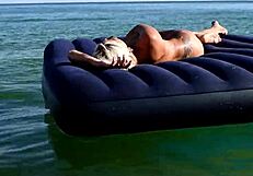 nude blonde beauty exposes big boobs on public beach with dolphin tattoo