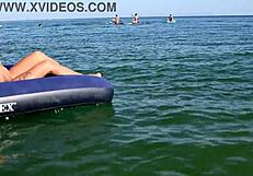 nude blonde beauty exposes big boobs on public beach with dolphin tattoo