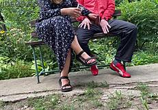 Milf subtly jerks big dick into glass on park bench